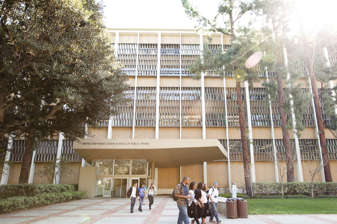 The outside of the Meyer and Renee Luskin School of Public Affairs with groups of students walking by.